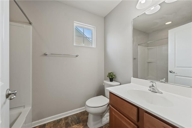 full bath with shower / washtub combination, toilet, vanity, and baseboards