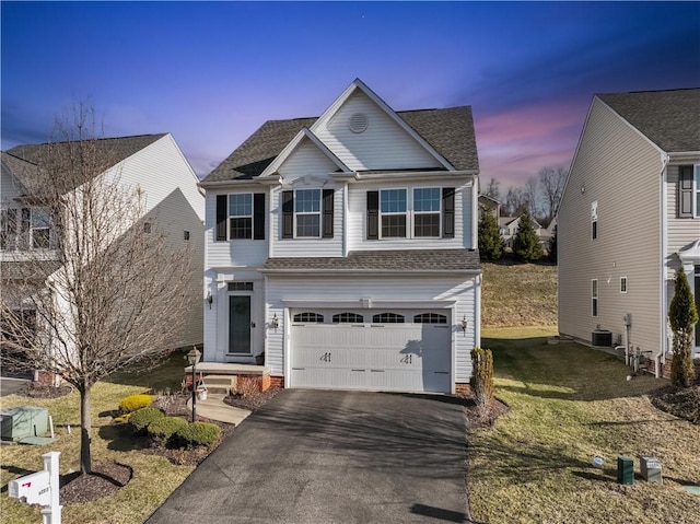 view of front of home featuring aphalt driveway, a front yard, roof with shingles, central AC unit, and a garage