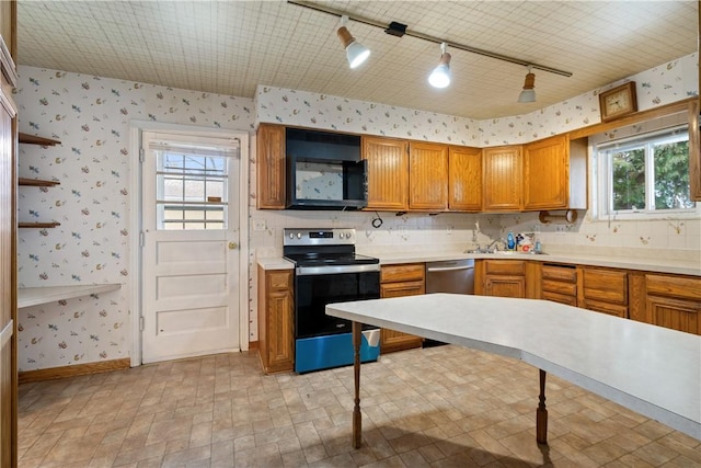 kitchen featuring wallpapered walls, electric range oven, black microwave, stainless steel dishwasher, and brown cabinets