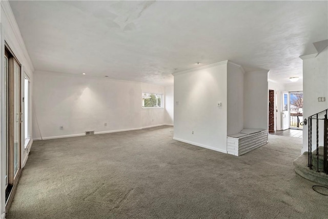 empty room with baseboards, ornamental molding, and carpet flooring