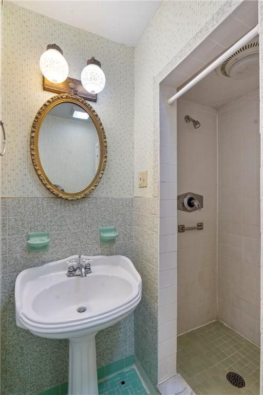 full bath featuring a shower stall and tile walls