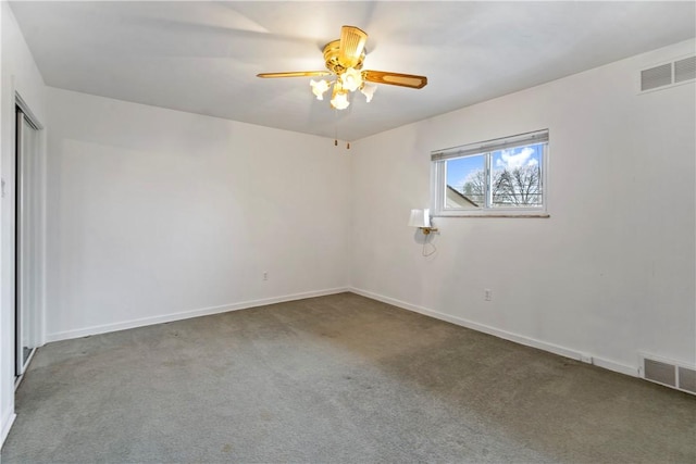 carpeted empty room with a ceiling fan, visible vents, and baseboards