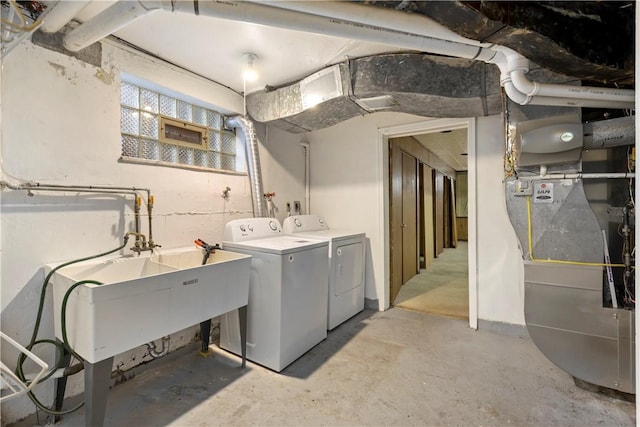 laundry room with laundry area, a sink, and separate washer and dryer