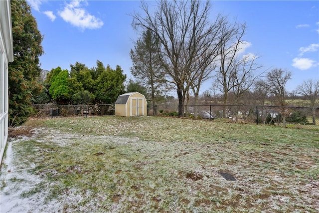 view of yard with an outbuilding, a storage shed, and a fenced backyard