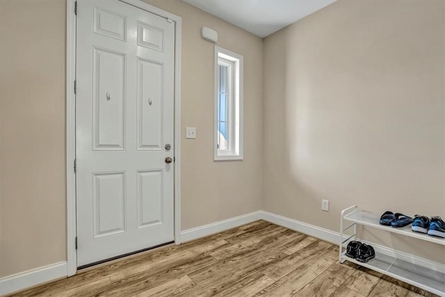 entryway featuring light wood finished floors and baseboards