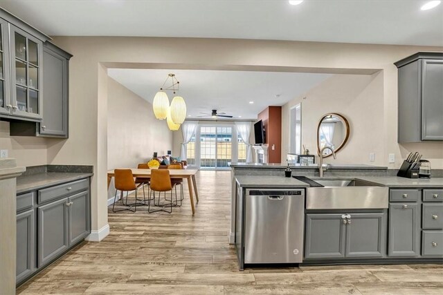 kitchen with a sink, light wood-type flooring, dishwasher, and gray cabinets