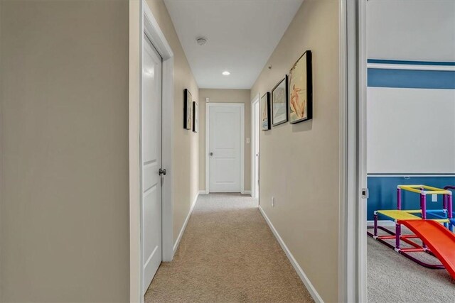 corridor featuring recessed lighting, baseboards, and carpet flooring