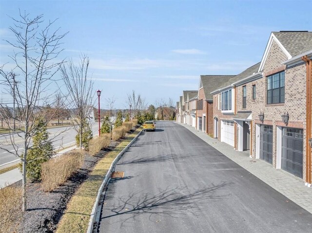 view of road with a residential view and curbs