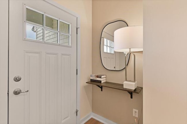 foyer entrance featuring baseboards