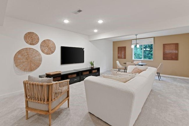 living room with recessed lighting, visible vents, baseboards, and light colored carpet