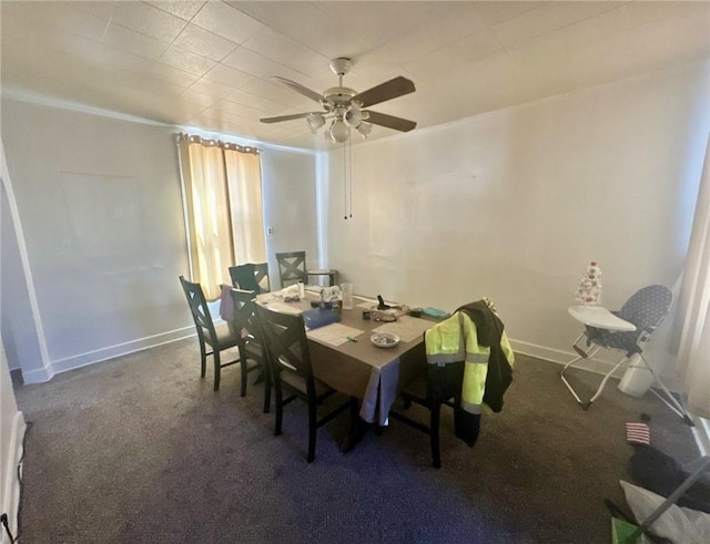 carpeted dining space with baseboards and ceiling fan