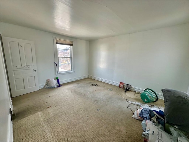 carpeted spare room featuring baseboards