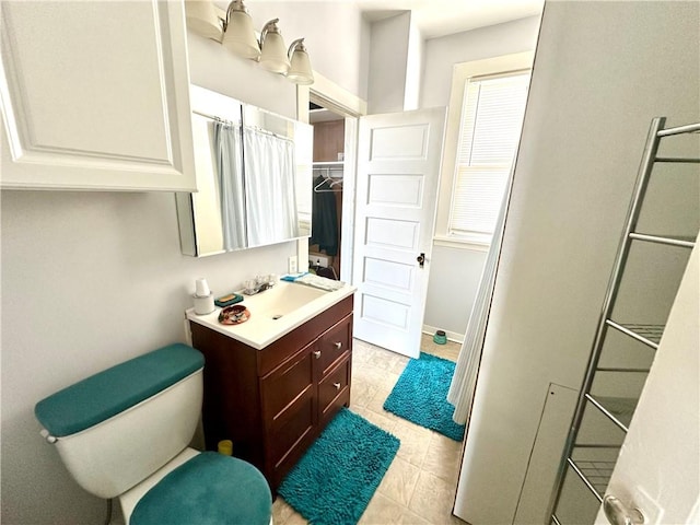 full bathroom featuring toilet, vanity, and baseboards