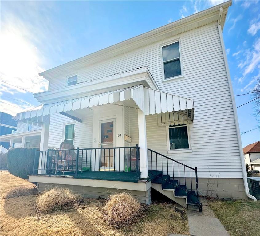 back of property with a porch