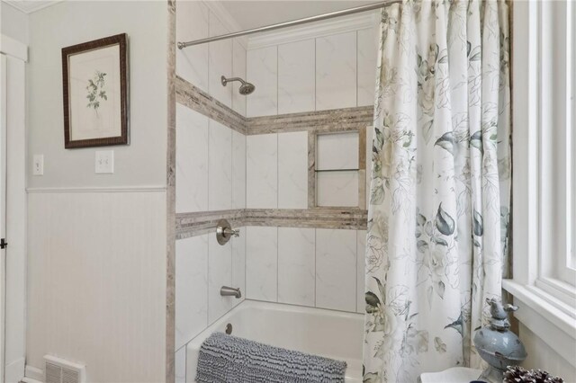 bathroom with visible vents and shower / tub combo with curtain