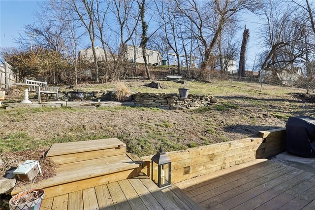 wooden terrace with a fenced backyard