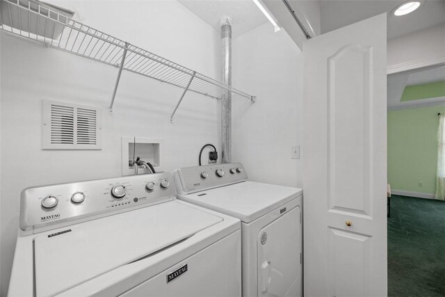 laundry area featuring laundry area, visible vents, dark colored carpet, and washing machine and clothes dryer