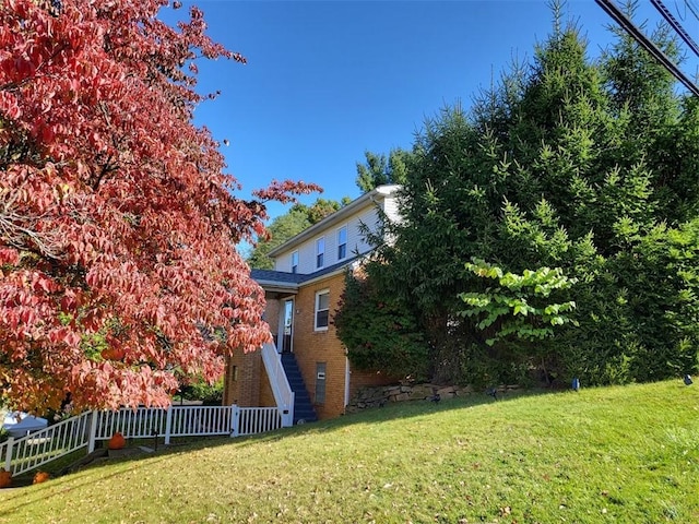 view of yard featuring stairs and fence