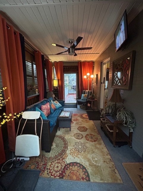 interior space with wood ceiling and a ceiling fan