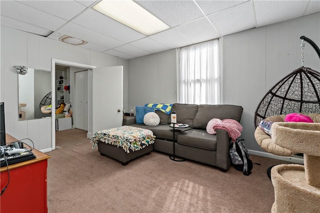 carpeted living room with a drop ceiling