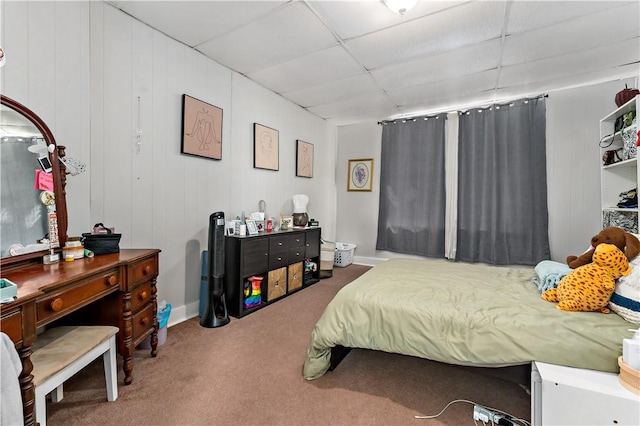 bedroom featuring a paneled ceiling and carpet