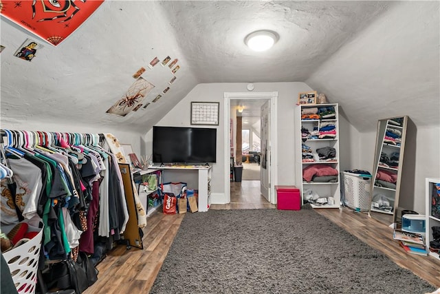 spacious closet featuring vaulted ceiling and wood finished floors