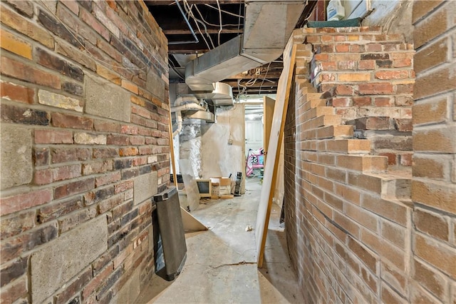 unfinished below grade area with brick wall