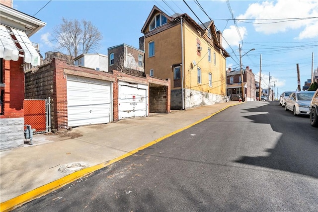 view of street with curbs, street lights, and sidewalks