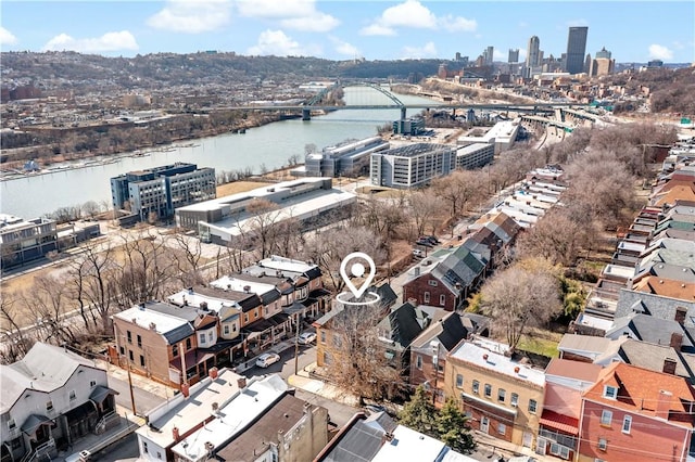 drone / aerial view featuring a view of city and a water view