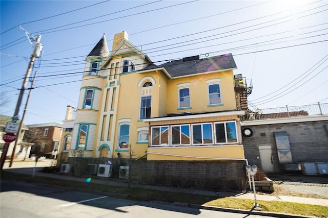 victorian-style house featuring stucco siding