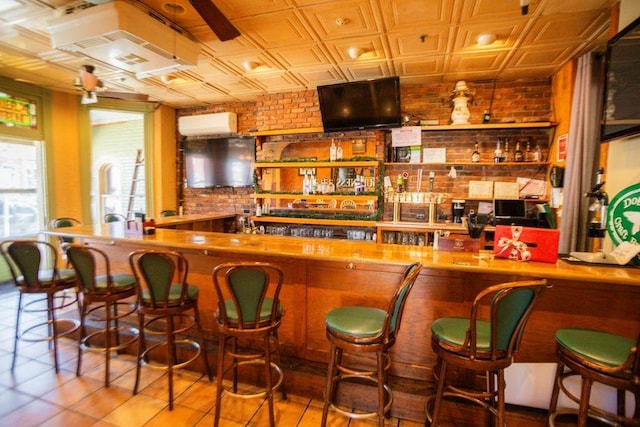 bar with an ornate ceiling, wet bar, and brick wall