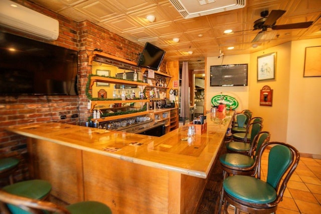 bar with a wall mounted AC, an ornate ceiling, brick wall, tile patterned flooring, and wet bar