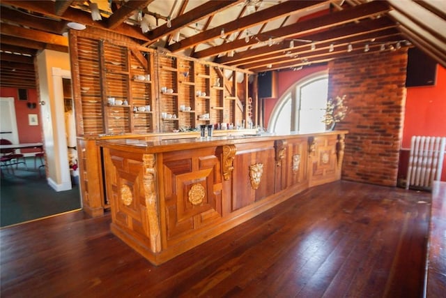 bar featuring wood-type flooring and brick wall