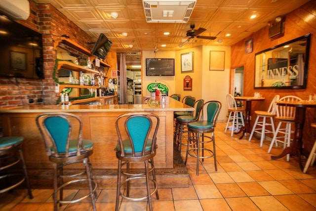 bar featuring wet bar, tile patterned floors, an ornate ceiling, and ceiling fan