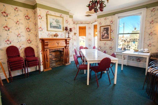 dining room with visible vents, a fireplace with flush hearth, wallpapered walls, carpet flooring, and crown molding