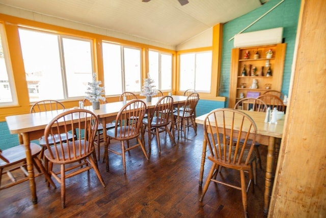 dining space with a healthy amount of sunlight, a ceiling fan, lofted ceiling, and wood-type flooring