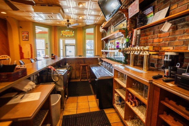 kitchen with brick wall, open shelves, light tile patterned flooring, an ornate ceiling, and ceiling fan