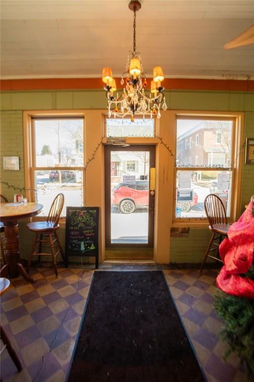 interior space featuring tile patterned floors and a notable chandelier