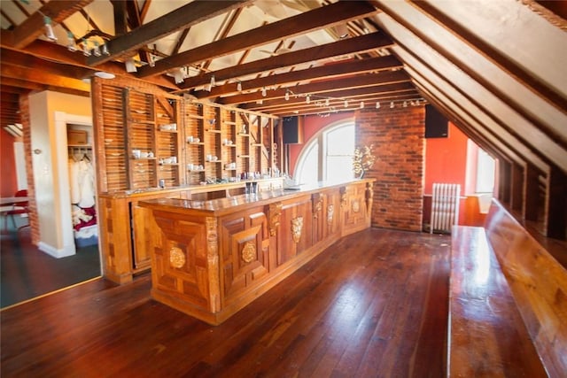 bar featuring lofted ceiling and dark wood-style flooring