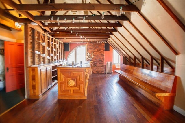 bar with radiator, dark wood-type flooring, and vaulted ceiling