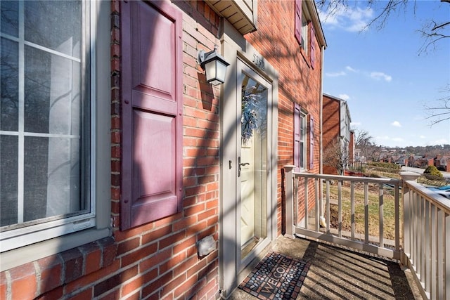 entrance to property featuring brick siding