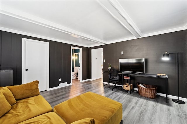 living room featuring beam ceiling, wood finished floors, and baseboards