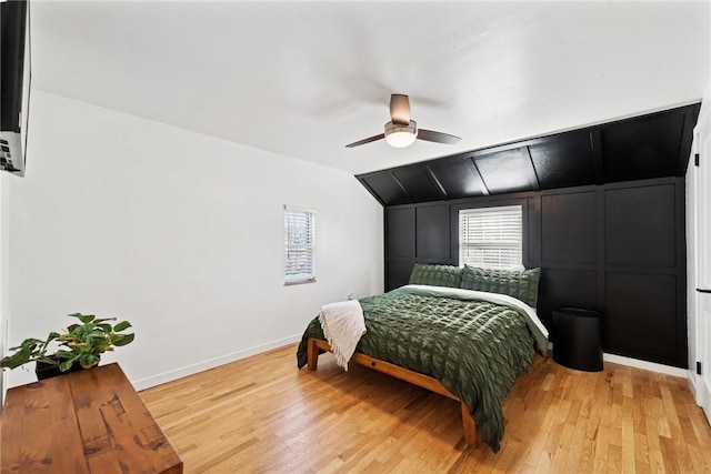 bedroom with vaulted ceiling, baseboards, light wood-type flooring, and ceiling fan