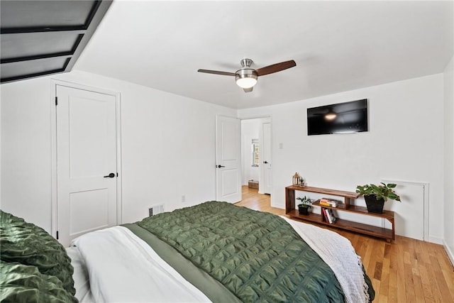 bedroom featuring visible vents, a ceiling fan, and light wood-style floors