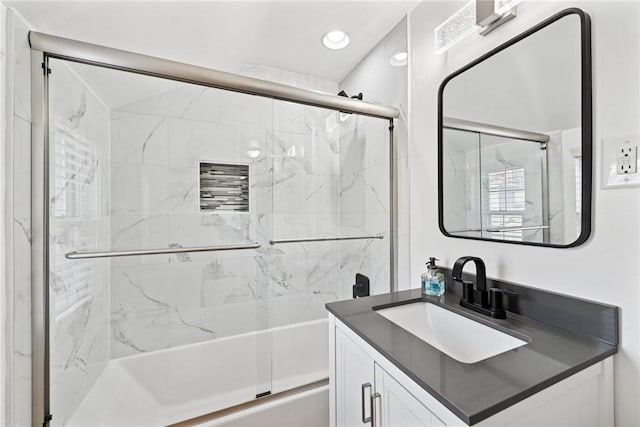 full bath featuring recessed lighting, vanity, and bath / shower combo with glass door