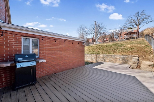 deck with a lawn and fence