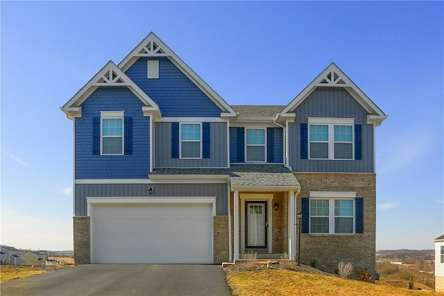 view of front of home featuring a garage, brick siding, board and batten siding, and driveway