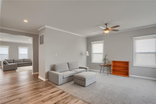 living area featuring visible vents, light wood-type flooring, and baseboards