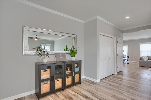 corridor featuring recessed lighting, baseboards, wood finished floors, and ornamental molding