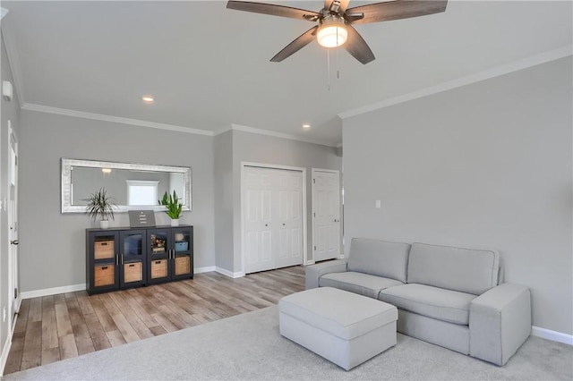 living area with ornamental molding, wood finished floors, recessed lighting, baseboards, and ceiling fan